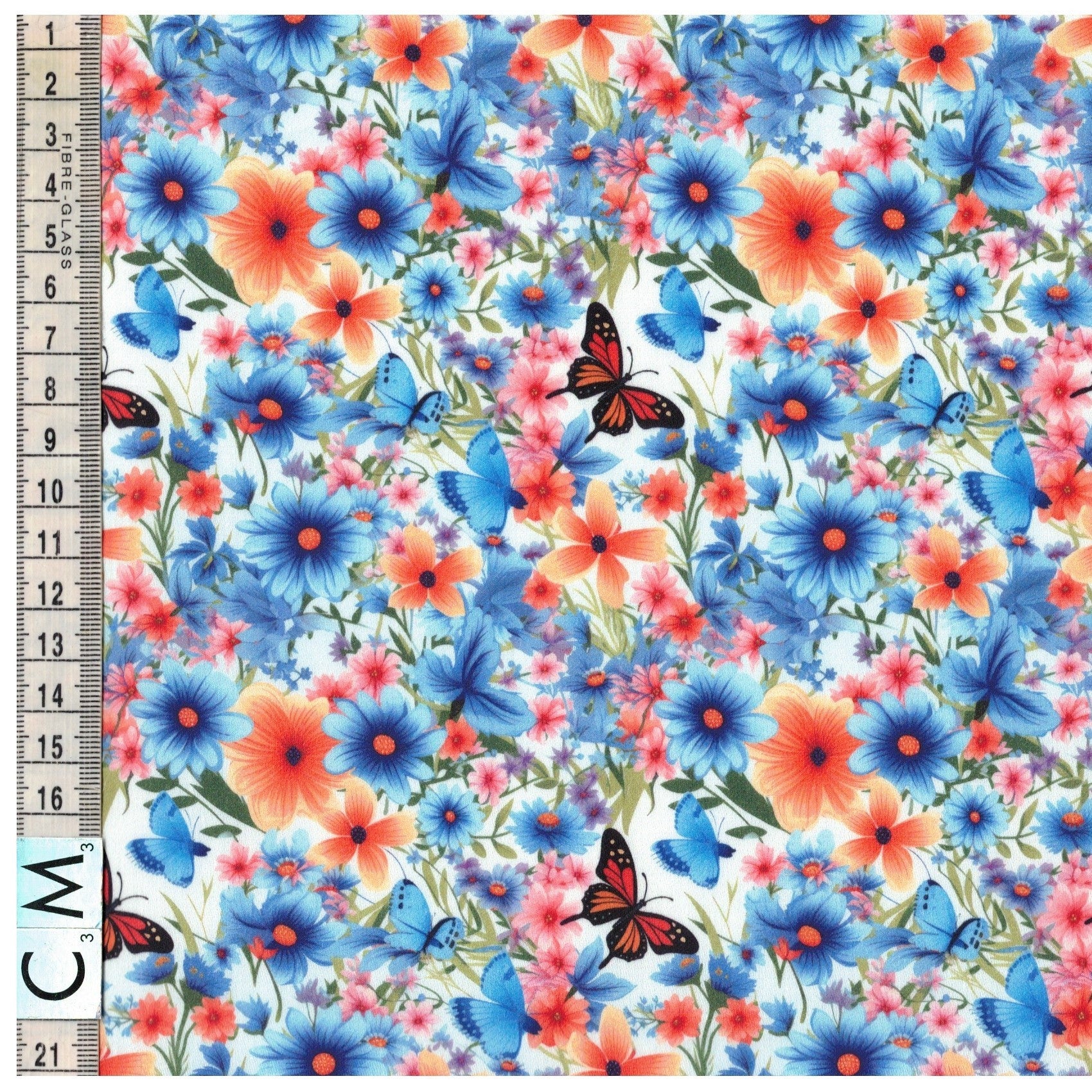 Floral fabric with blue, orange, and pink flowers and butterflies on a white background, with a ruler for scale.