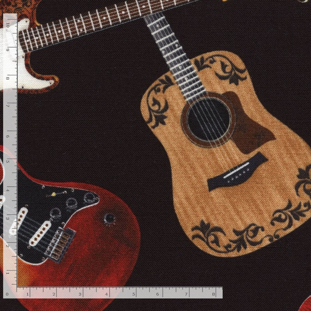 Fabric with acoustic and electric guitars on a black background, measured with a ruler.